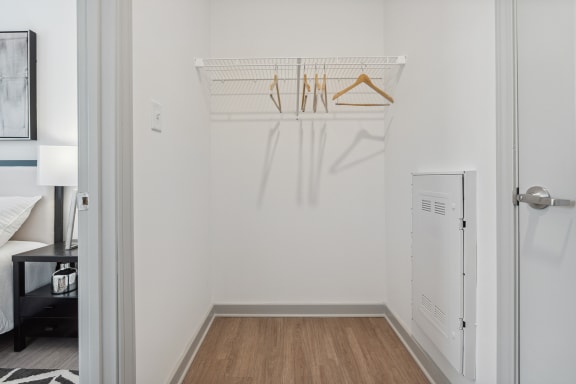 a bedroom with a white walls and a wooden floor at The Constellation Apartments, PRG Real Estate, Hampton, Virginia