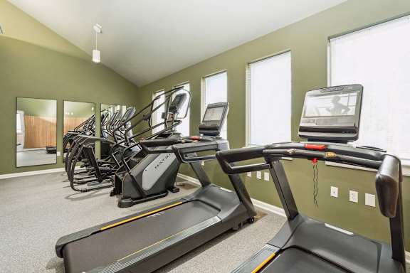 A gym with treadmills and exercise bikes at The Courtyards of Chanticleer Apartments, Virginia Beach 23451