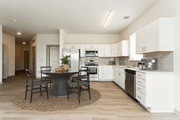 a kitchen and dining room with a table and chairs at The Waterford At Rocketts Landing Apartments, PRG Real Estate, Richmond, Virginia