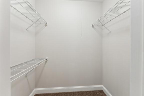Empty white shelves in a room.