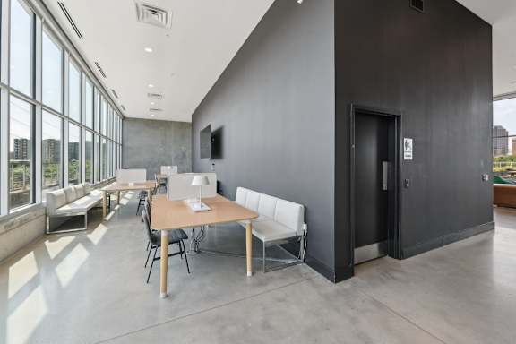 A modern room with a long table and chairs. at South Falls Tower Apartments, Richmond, Virginia
