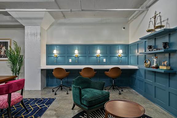 A room with a blue wall and a white table with chairs.
