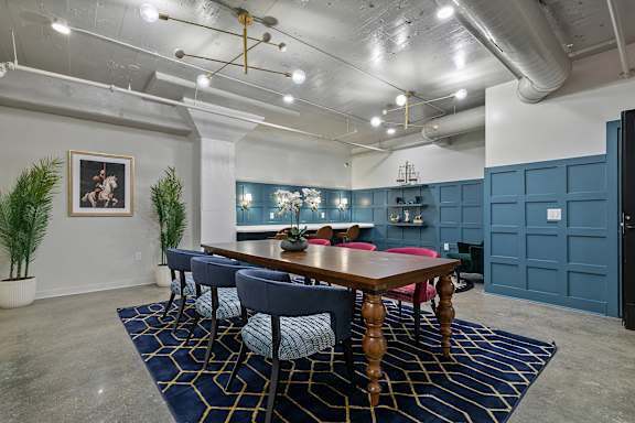 A conference room with a long table and chairs.