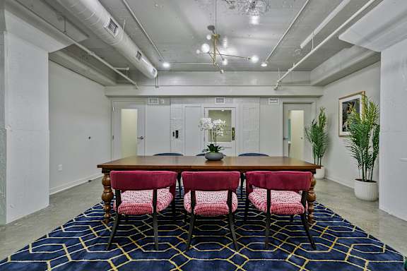 A conference room with a long table and chairs.