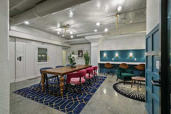 A room with a long table and chairs.