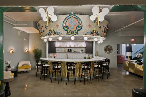 A bar area with a large circular mural on the wall.
