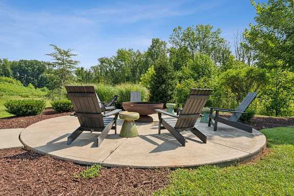 a patio with four chairs and a fire pit at Beckett Farms Apartments, PRG Real Estate Management, Fort Mill, SC