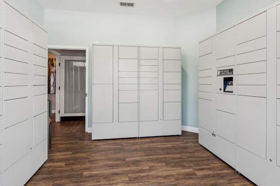 A room with white cupboards and wooden floors. at The Timbers Apartments, Richmond, Virginia
