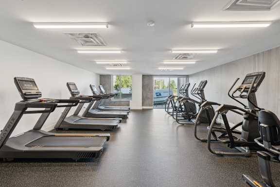 A gym with treadmills and elliptical machines. at South Falls Tower Apartments, Virginia