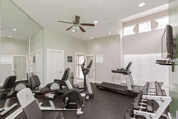 A spacious home gym with a variety of exercise equipment. at Beacon Ridge Apartments, PRG Real Estate Management, Greenville, SC 29615