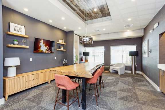 a dining room with a table and chairs and a fireplace  at Palm Crossing, Florida