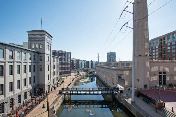 A canal runs through a city with buildings on either side.
