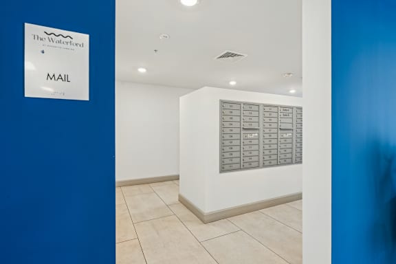 A white wall with a mail sign and a mailbox at The Waterford At Rocketts Landing Apartments, PRG Real Estate, Richmond, VA