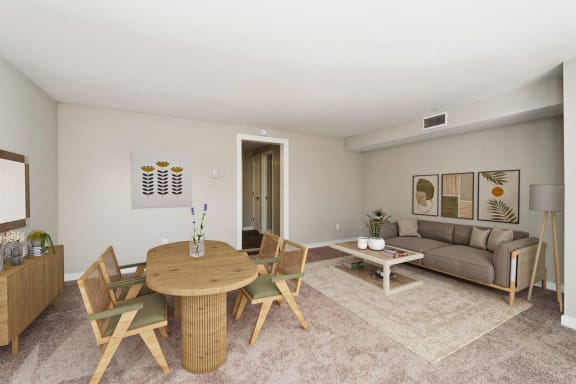a living room with a table and a couch at Hyde Park Townhomes, PRG Real Estate Management, Chester, VA