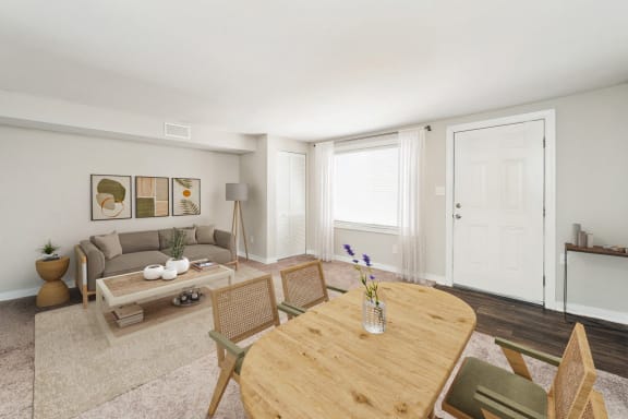 a living room and dining room with white walls and a wooden table at Hyde Park Townhomes, PRG Real Estate Management, Chester, VA