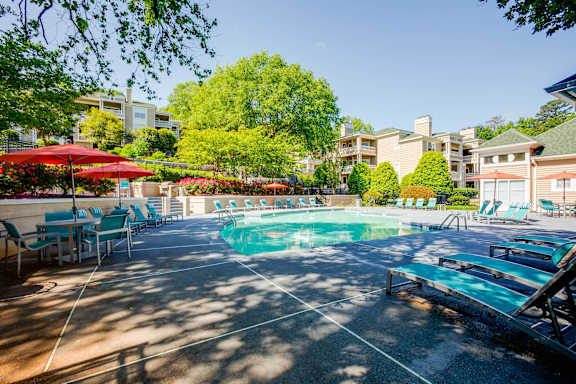 our apartments have a large pool with chairs and umbrellas at Beacon Ridge Apartments, PRG Real Estate Management, Greenville, SC 29615
