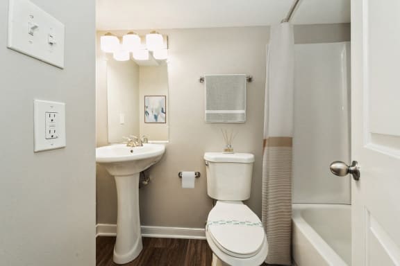 a bathroom with a toilet and a sink and a shower at Hyde Park Townhomes, PRG Real Estate Management, Chester, VA