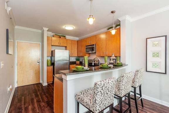 A kitchen with a refrigerator, microwave, and oven at 45 Madison Apartments, Kansas City, 64111