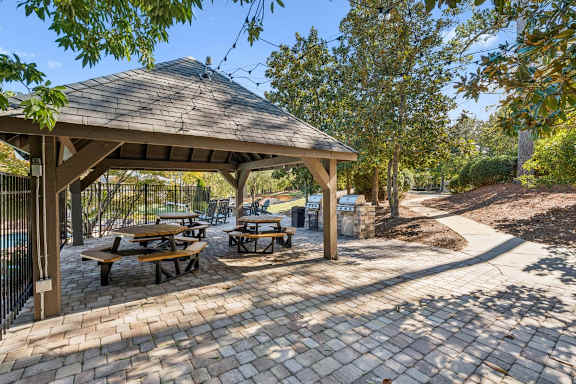 A gazebo with picnic tables is surrounded by trees. at Park Ridge Estates, North Carolina