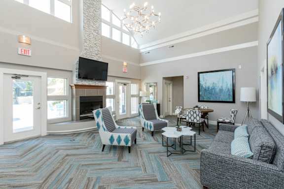 a living room with couches and chairs and a fireplace at Beacon Ridge Apartments, PRG Real Estate Management, Greenville, SC 29615