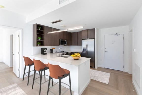 a kitchen with a large island with three stools at Hydro, Richmond, VA