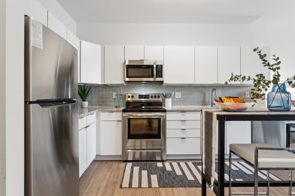 a kitchen with white cabinetry and stainless steel appliances at The Constellation Apartments, PRG Real Estate, Hampton, Virginia