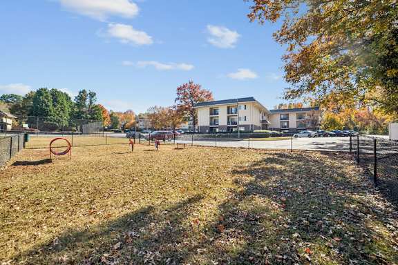 A park with a playground and a building in the background at Lakecrest Apartments, PRG Real Estate Management, Greenville, SC 29615