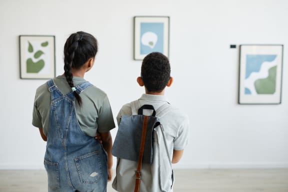 two young boys looking at paintings in an art gallery at The Box, Virginia