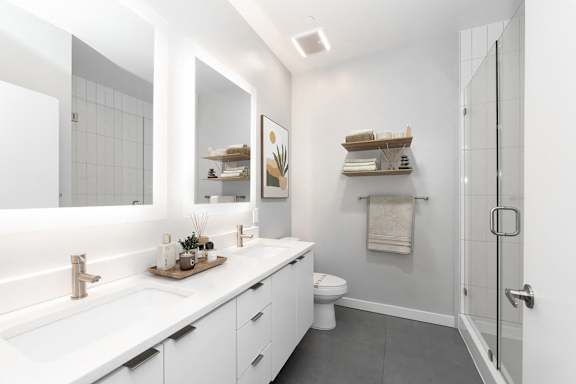 A modern bathroom with a white countertop and a white sink. at The Locks Tower, Richmond, VA, 23219
