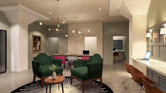 A modern office space with green chairs and a coffee table in the center at The Carousel, Richmond, VA 23220