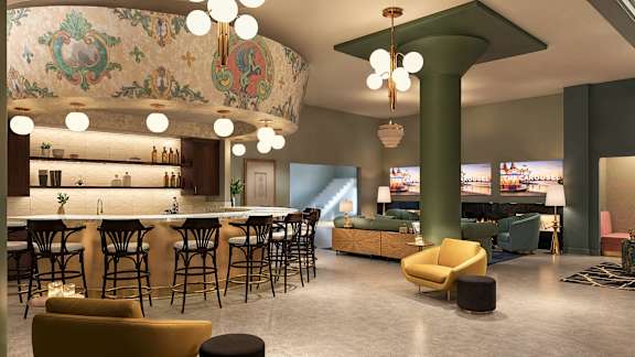 A modern bar with a green pillar and a mural on the wall at The Carousel, Virginia 23220