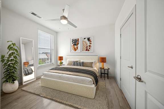 A bedroom with a bed, a ceiling fan, and a potted plant at Circ Apartments, Virginia