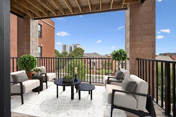 A patio with a table and chairs overlooking a city at Circ Apartments, Virginia