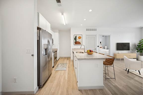 A modern kitchen with white appliances and a wooden floor at Circ Apartments, Virginia