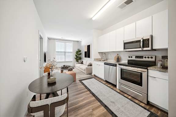 A modern kitchen with a dining table and chairs at Circ Apartments, Virginia