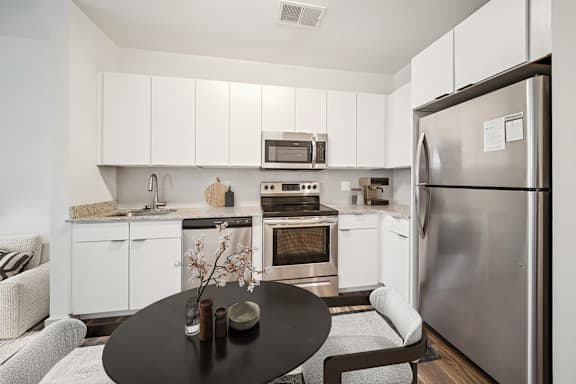 A modern kitchen with a refrigerator, oven, and microwave at Circ Apartments, Virginia