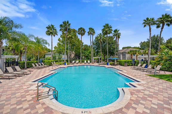 Large swimming pool with paver deck and lounge chairs at Citrus Tower Apartments, Clermont, Florida