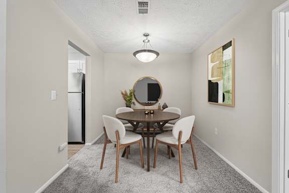 Dedicated dining area with seating for four and open access to kitchen