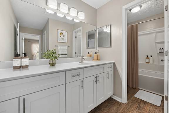 A bathroom with a vanity and a mirror.