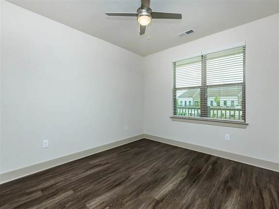 Wood-style flooring, ceiling fan and window in an apartment at Berewick Pointe