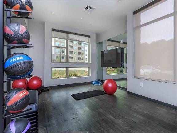 Yoga area in the fitness center has weighted balls and floor mats at Berewick Pointe Apartments in Charlotte, NC