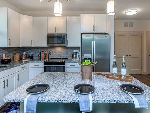 Large model kitchen with stainless steel appliances and an island at Berewick Pointe Apartments