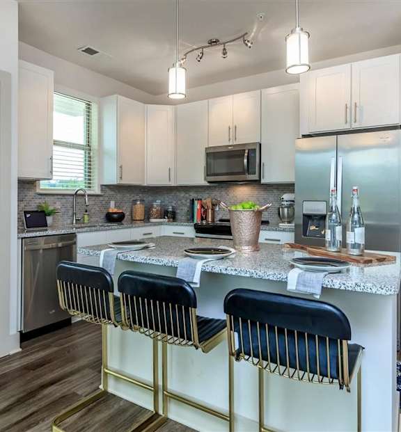 Model kitchen with stainless steel appliances and an island at Berewick Pointe Apartments in Charlotte, NC.