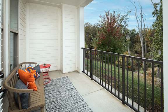 Private balcony with railing and tree views at Pointe at Research Park Apartments, Charlotte, NC