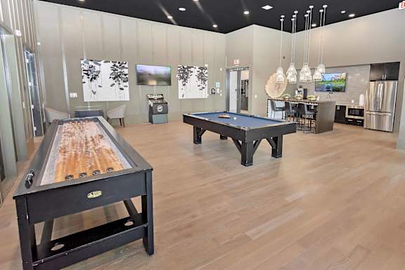 Game room with pool table shuffleboard and kitchenette at TRAILSIDE VERDAE Apartments, GREENVILLE, South Carolina