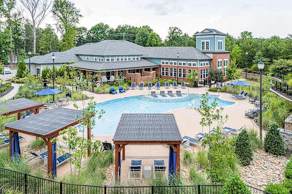 Aerial view of pool area with cabanas and clubhouse at TRAILSIDE VERDAE Apartments, South Carolina, 29607