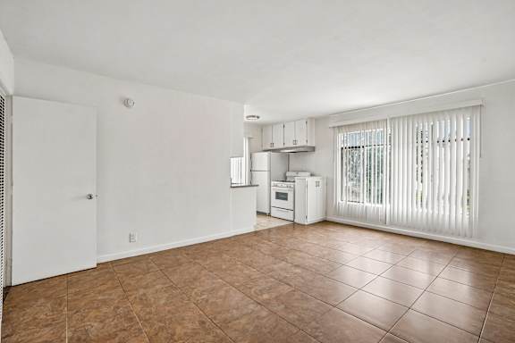 A kitchen area with a refrigerator, microwave, and oven.