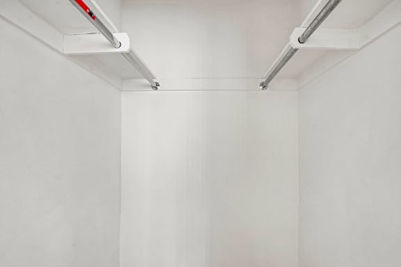 A white wall with a red and silver light fixture.