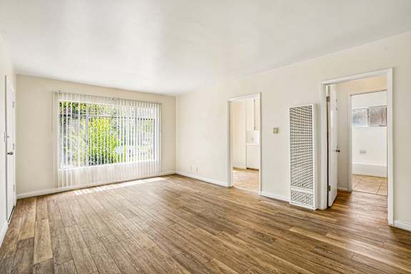 A room with wooden floors and white walls.