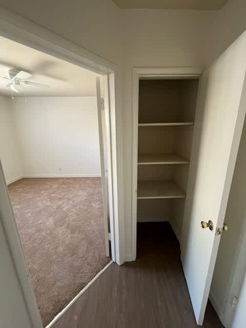 A room with a carpeted floor and a white door.